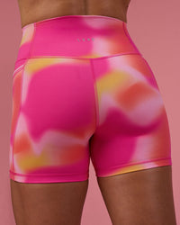 Woman wearing Fusion Ultra High-Rise 4" Short Pockets - Pink Glow Print | Model:Hannah | Size:S