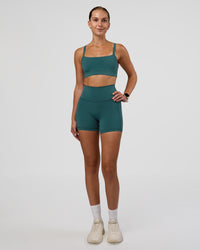 Woman wearing Fusion Ultra High-Rise 4" Short Pockets - Transformative Teal | Model:Myrte | Size:S