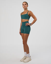 Woman wearing Fusion Ultra High-Rise 4" Short Pockets - Transformative Teal | Model:Myrte | Size:S