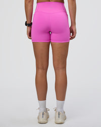 Woman wearing Fusion Ultra High-Rise 4" Short Pockets - Ultra Fuchsia | Set:true | Angle:back | Model:Abbey | Size:S