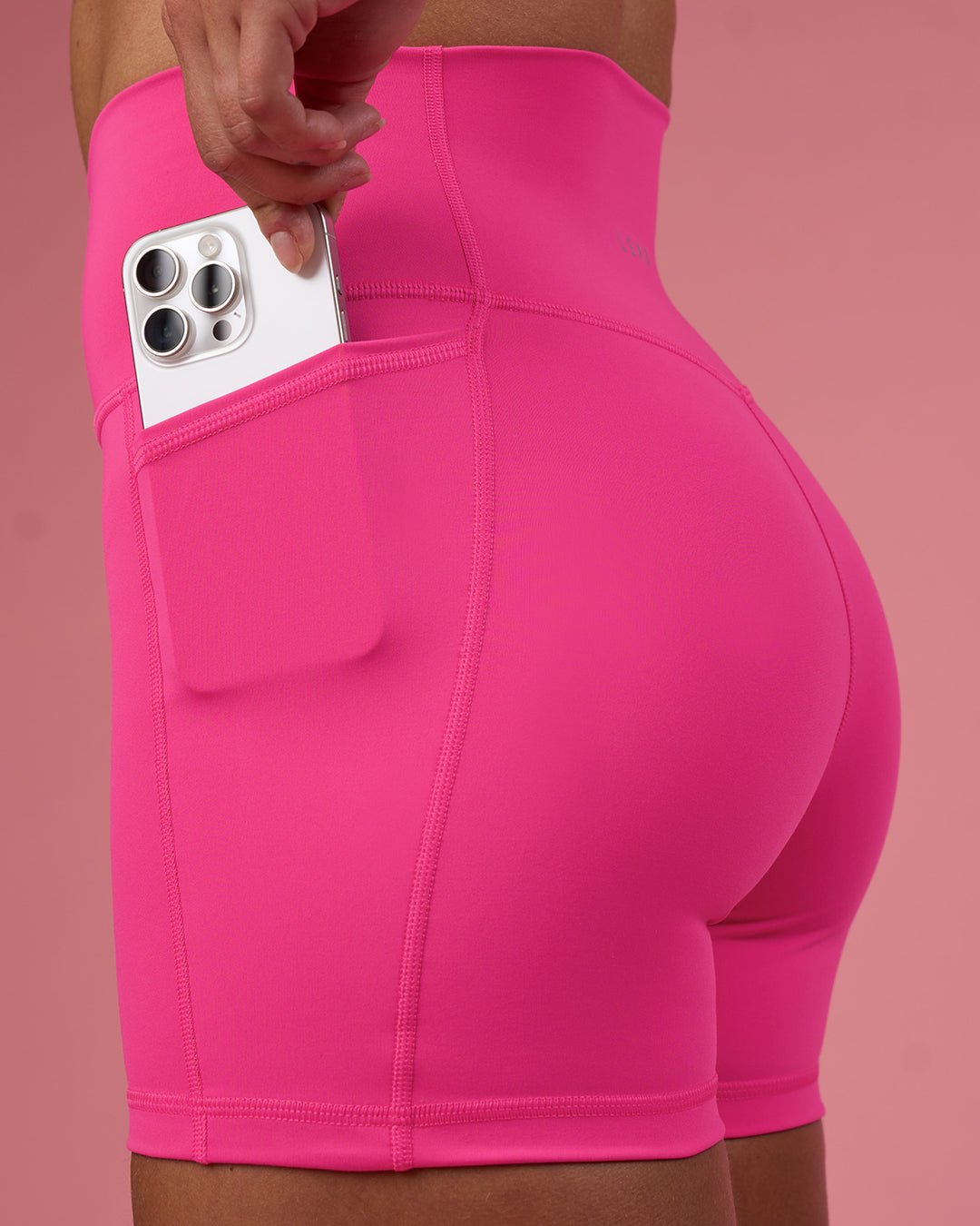 Woman wearing Fusion Ultra High-Rise 4&quot; Short Pockets - Ultra Pink | Model:Hannah | Size:S