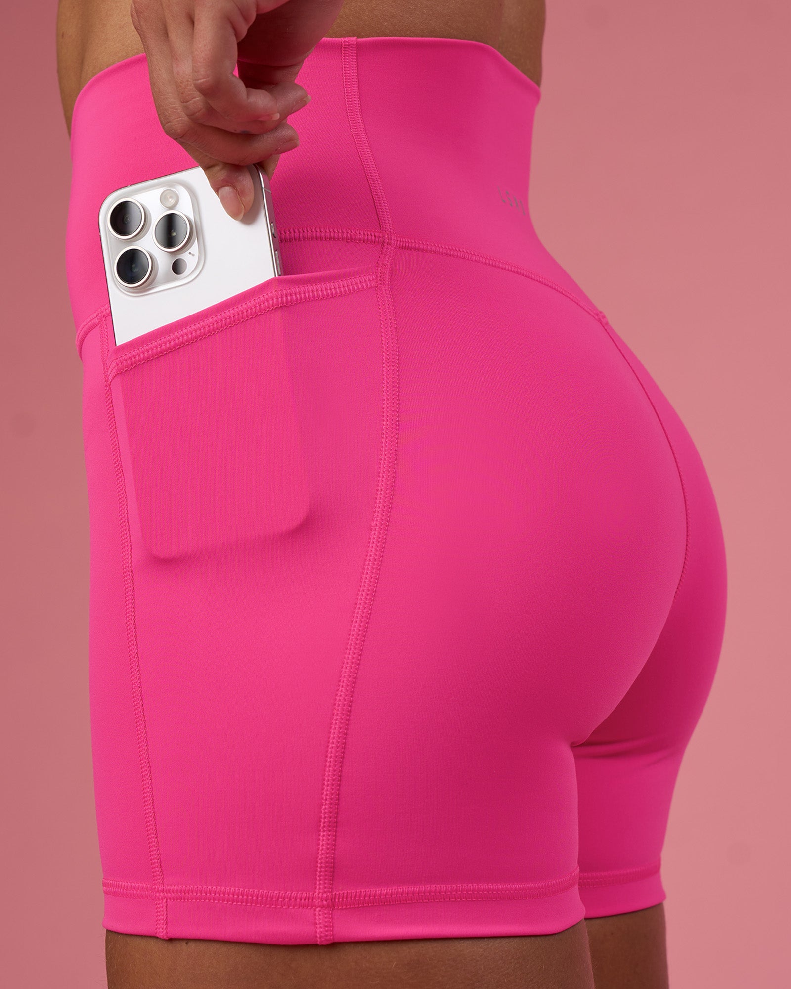 Woman wearing Fusion Ultra High-Rise 4" Short Pockets - Ultra Pink | Model:Hannah | Size:S