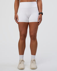 Woman wearing Fusion Ultra High-Rise 4" Short Pockets - White | Set:true | Angle:front | Model:Sav | Size:S