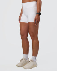 Woman wearing Fusion Ultra High-Rise 4" Short Pockets - White | Set:true | Angle:side | Model:Sav | Size:S