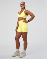 Woman wearing Fusion Ultra High-Rise 4" Short Pockets - Yellow Fizz | Model:Sav | Size:S