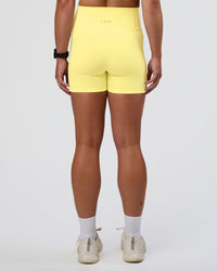 Woman wearing Fusion Ultra High-Rise 4" Short Pockets - Yellow Fizz | Set:true | Angle:back | Model:Sav | Size:S