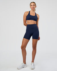 Woman wearing Fusion Ultra High-Rise 6" Short - Future Navy | Model:Evie | Size:S