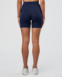 Woman wearing Fusion Ultra High-Rise 6" Short - Future Navy | Set:true | Angle:back | Model:Evie | Size:S