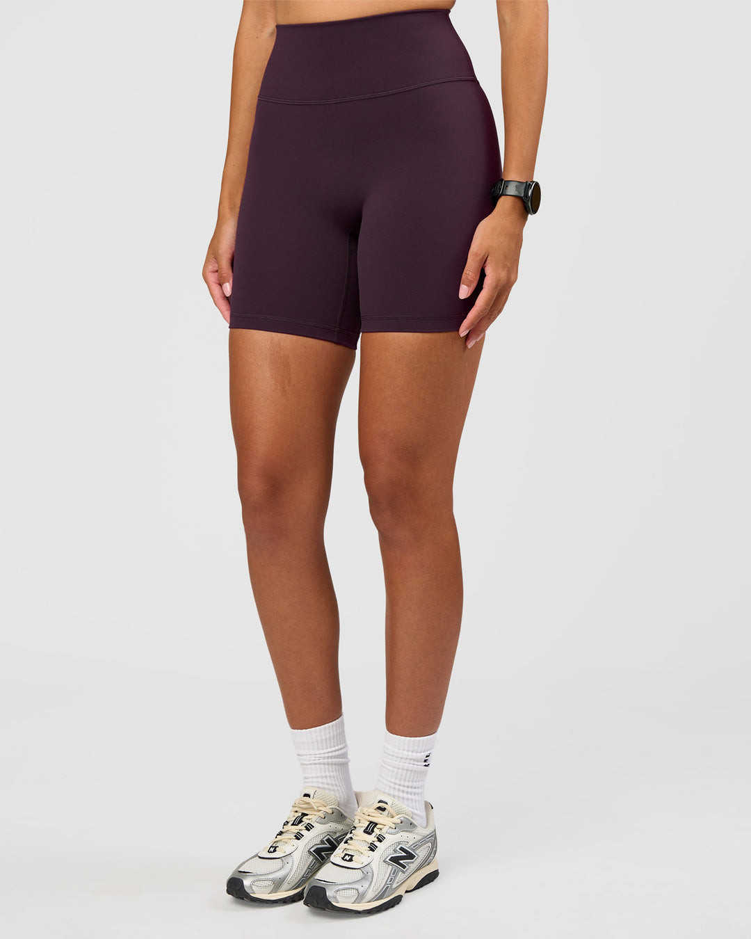 Woman wearing Fusion Ultra High-Rise 6" Short - Midnight Plum | Set:true | Angle:side | Model:Rhiley | Size:S