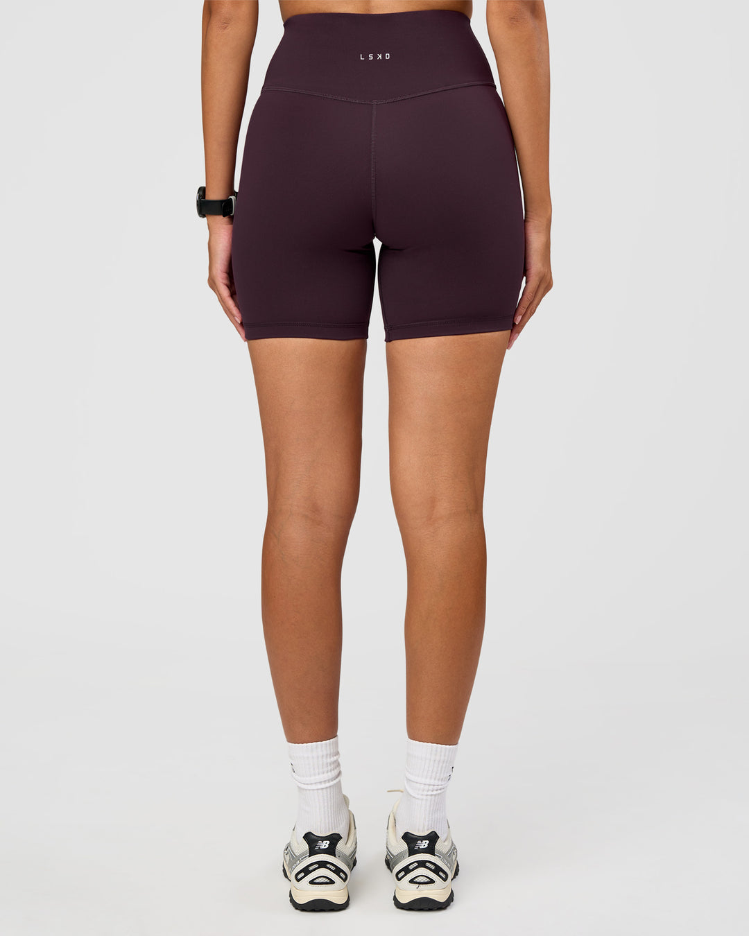 Woman wearing Fusion Ultra High-Rise 6" Short - Midnight Plum | Set:true | Angle:back | Model:Rhiley | Size:S