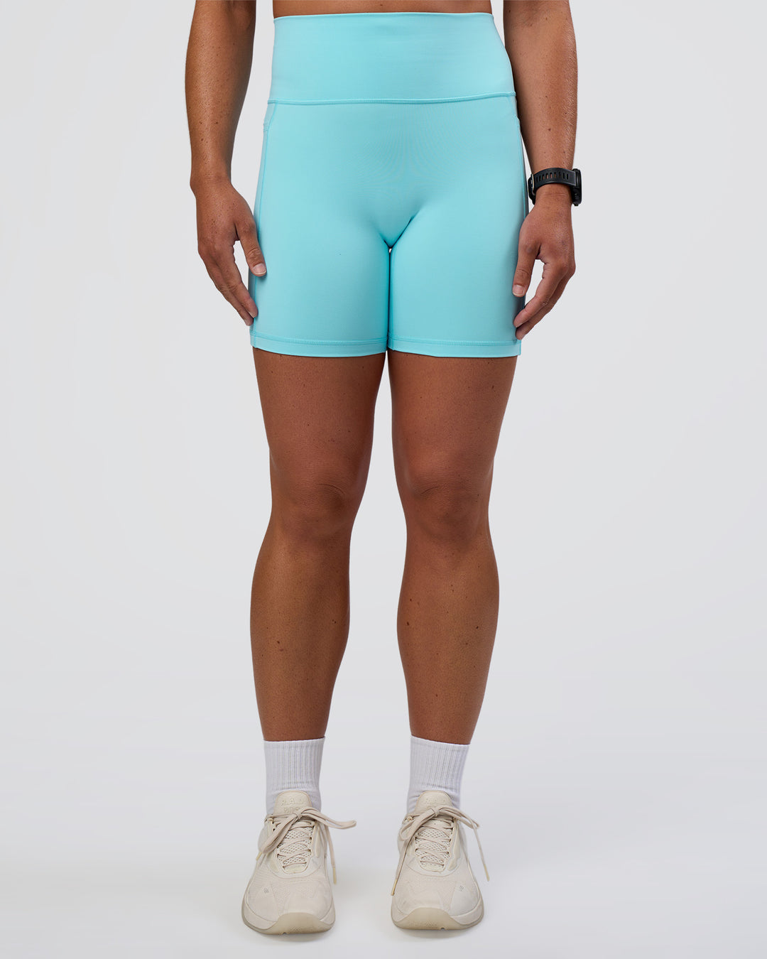 Woman wearing Fusion Ultra High-Rise 6&quot; Short Pockets - Baltic Sea | Model:Sav | Size:S