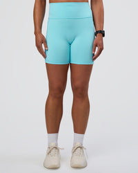 Woman wearing Fusion Ultra High-Rise 6" Short Pockets - Baltic Sea | Set:true | Angle:front | Model:Sav | Size:S