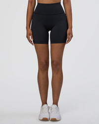 Woman wearing Fusion Ultra High-Rise 6" Short Pockets - Black | Set:true | Angle:front | Model:Jordan | Size:S