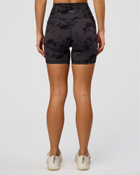 Woman wearing Fusion Ultra High-Rise 6" Short Pockets - Black Tie Dye | Set:true | Angle:back | Model:Amity | Size:S