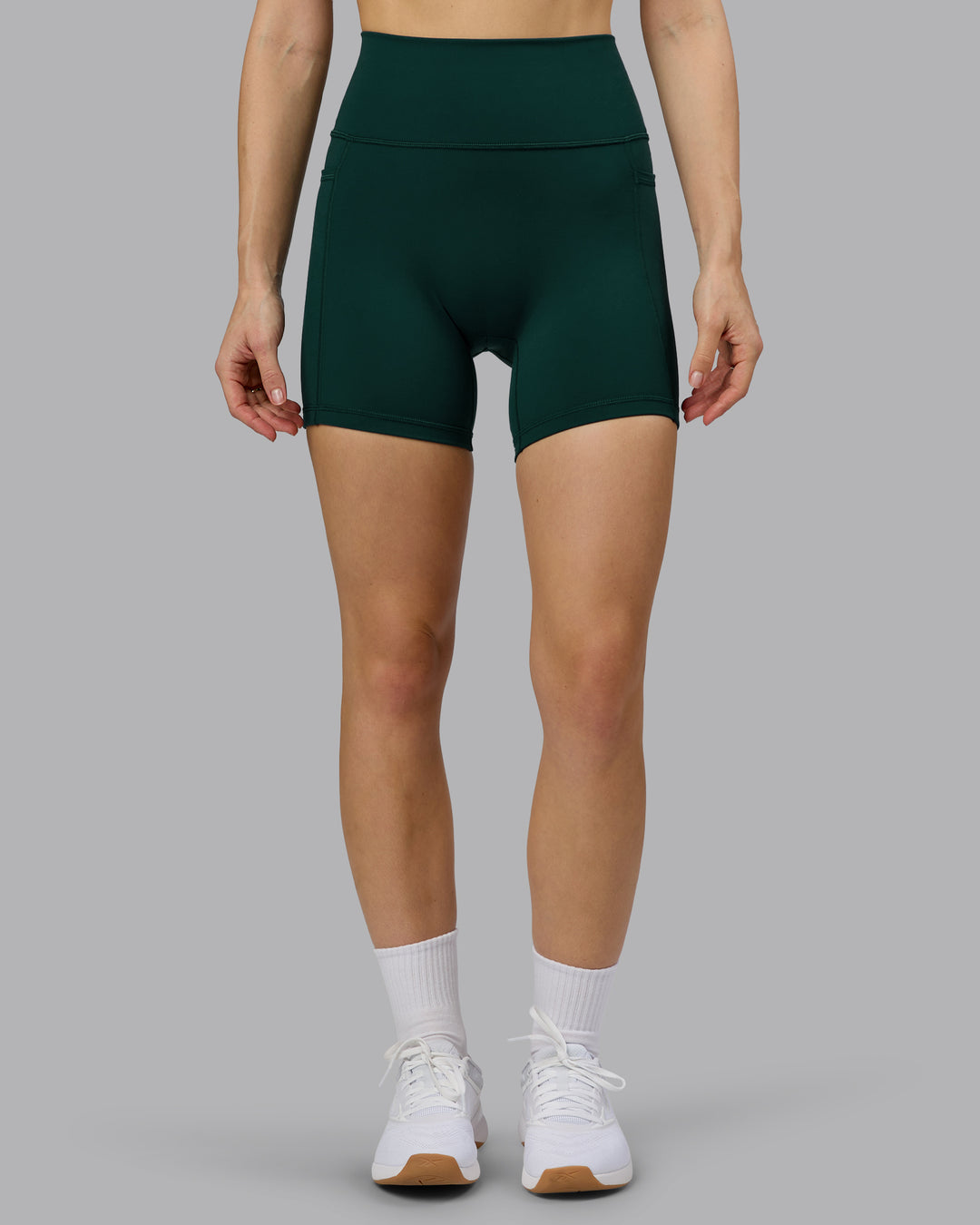 Woman wearing Fusion Ultra High-Rise 6" Short Pockets - Dark Moss | Model:Emilie | Size:S