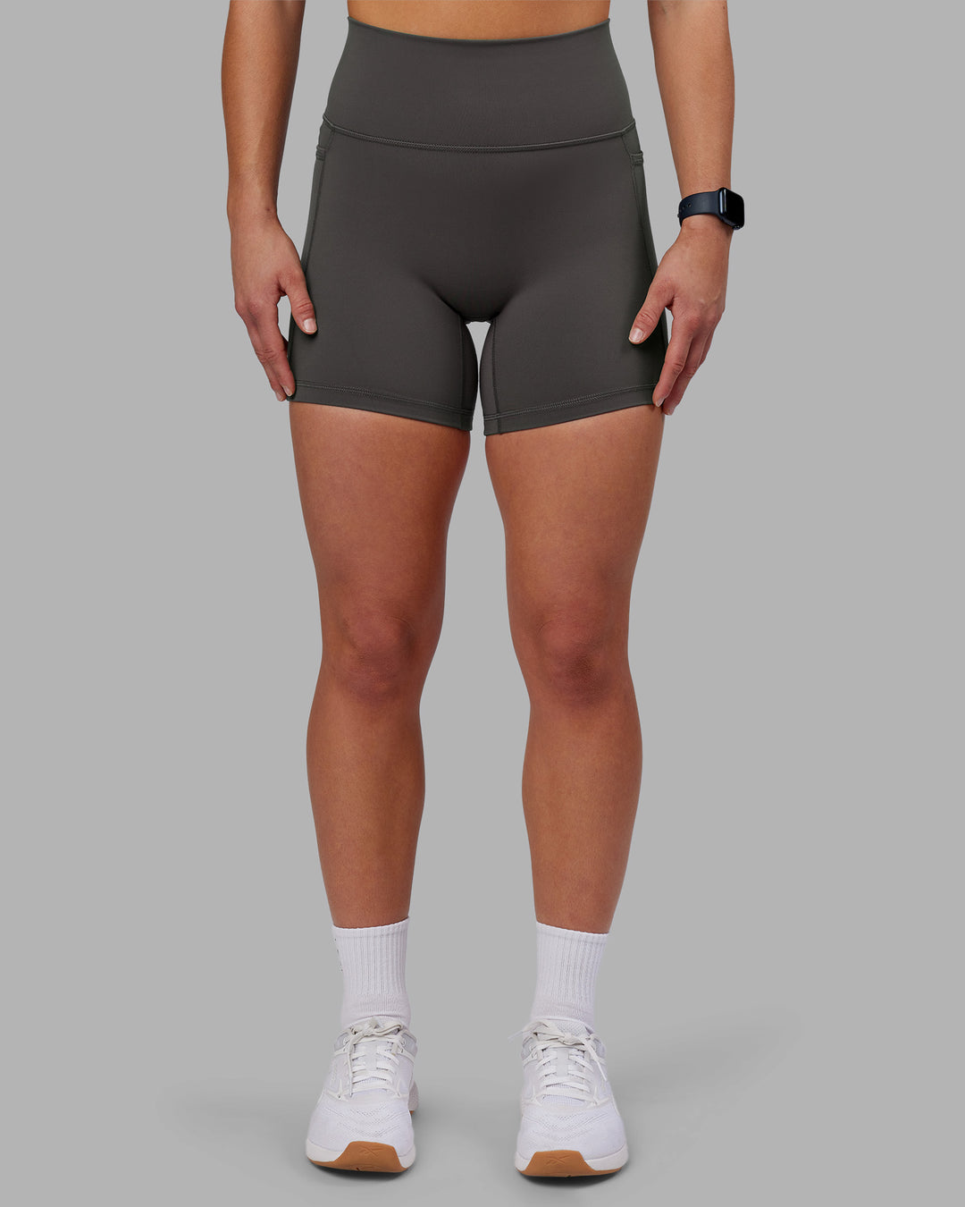 Woman wearing Fusion Ultra High-Rise 6&quot; Short Pockets - Dark Storm | Model:Keisha | Size:S
