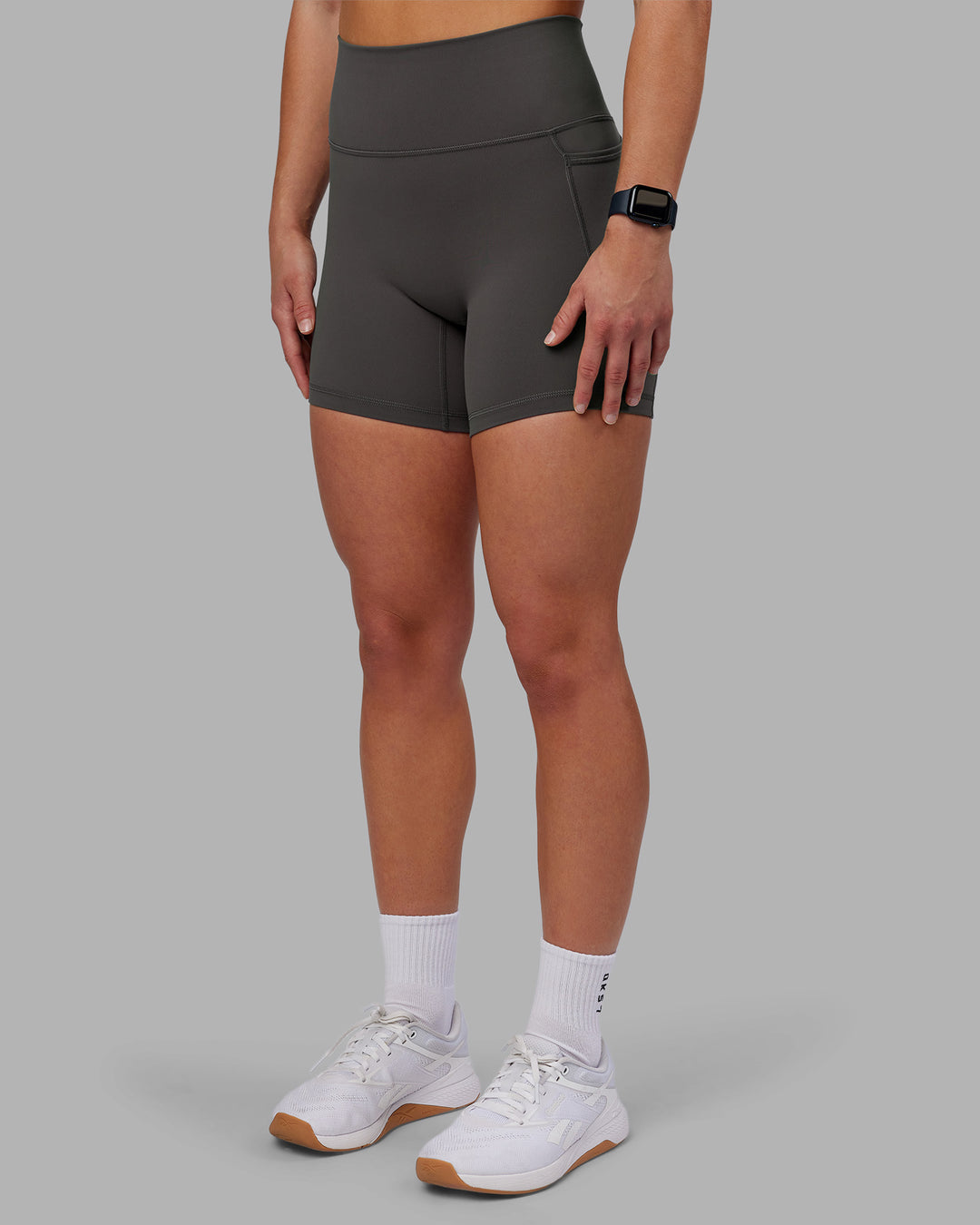 Woman wearing Fusion Ultra High-Rise 6&quot; Short Pockets - Dark Storm | Model:Keisha | Size:S