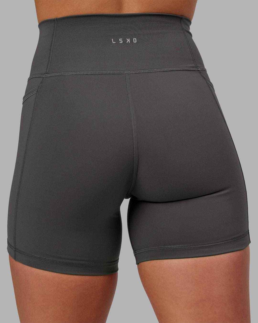 Woman wearing Fusion Ultra High-Rise 6&quot; Short Pockets - Dark Storm | Model:Keisha | Size:S