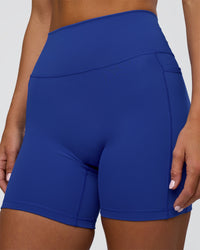 Woman wearing Fusion Ultra High-Rise 6" Short Pockets - Electric Indigo | Model:Amity | Size:S