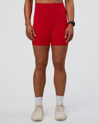 Woman wearing Fusion Ultra High-Rise 6" Short Pockets - Flame | Set:true | Angle:front | Model:Sav | Size:S