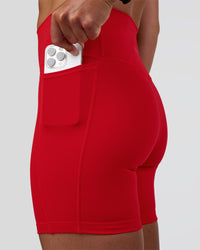 Woman wearing Fusion Ultra High-Rise 6" Short Pockets - Flame | Set:true | Angle:closeup | Model:Sav | Size:S