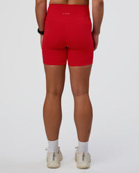 Woman wearing Fusion Ultra High-Rise 6" Short Pockets - Flame | Set:true | Angle:back | Model:Sav | Size:S