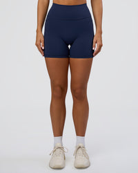 Woman wearing Fusion Ultra High-Rise 6" Short Pockets - Future Navy | Set:true | Angle:front | Model:Amity | Size:S