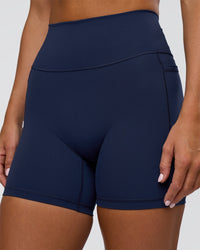 Woman wearing Fusion Ultra High-Rise 6" Short Pockets - Future Navy | Model:Amity | Size:S