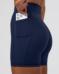 Woman wearing Fusion Ultra High-Rise 6" Short Pockets - Future Navy | Set:true | Angle:closeup | Model:Amity | Size:S
