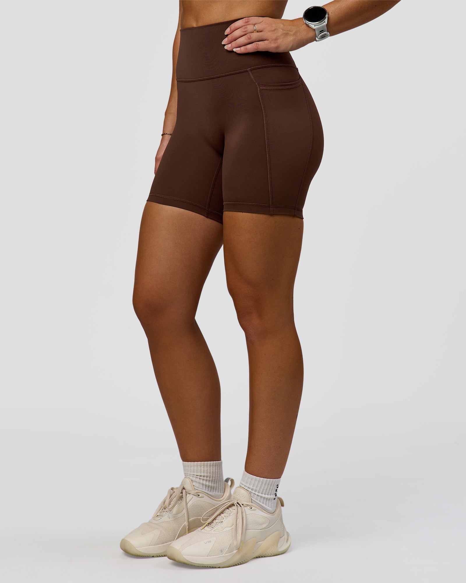 Woman wearing Fusion Ultra High-Rise 6" Short Pockets - Hot Chocolate | Model:Summer | Size:S