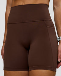 Woman wearing Fusion Ultra High-Rise 6" Short Pockets - Hot Chocolate | Model:Summer | Size:S