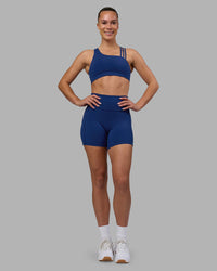Woman wearing Fusion Ultra High-Rise 6" Short Pockets - Midnight Blue | Model:Charlize | Size:S