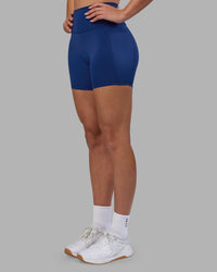 Woman wearing Fusion Ultra High-Rise 6" Short Pockets - Midnight Blue | Model:Charlize | Size:S