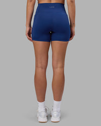 Woman wearing Fusion Ultra High-Rise 6" Short Pockets - Midnight Blue | Model:Charlize | Size:S
