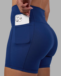 Woman wearing Fusion Ultra High-Rise 6" Short Pockets - Midnight Blue | Model:Charlize | Size:S