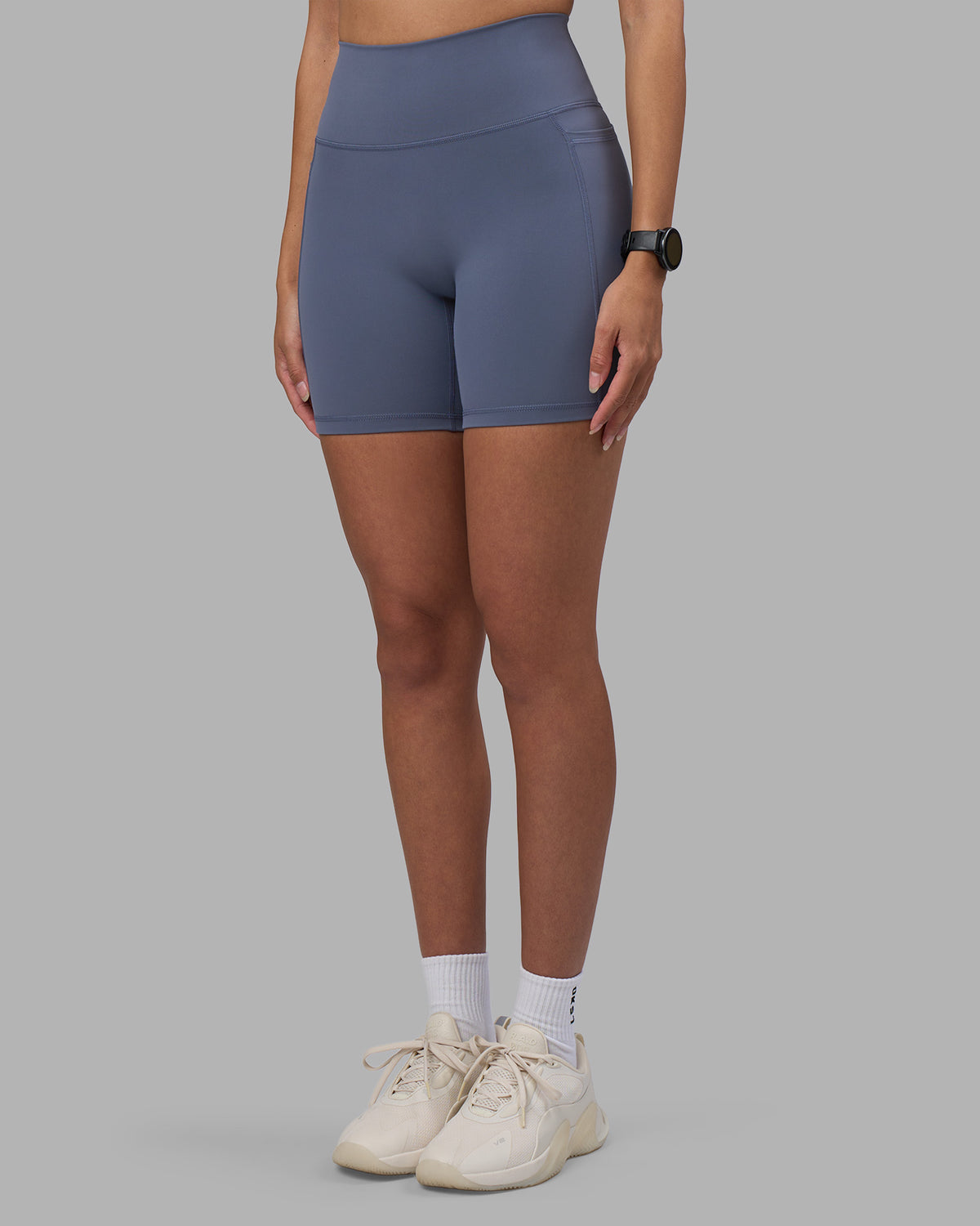 Woman wearing Fusion Ultra High-Rise 6" Short Pockets - Night Shadow | Model:Rhiley | Size:S