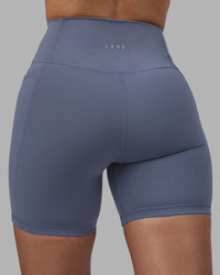 Woman wearing Fusion Ultra High-Rise 6" Short Pockets - Night Shadow | Model:Rhiley | Size:S