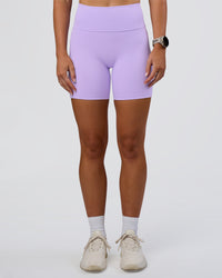 Woman wearing Fusion Ultra High-Rise 6" Short Pockets - Pale Lilac | Set:true | Angle:front | Model:Emelia | Size:S