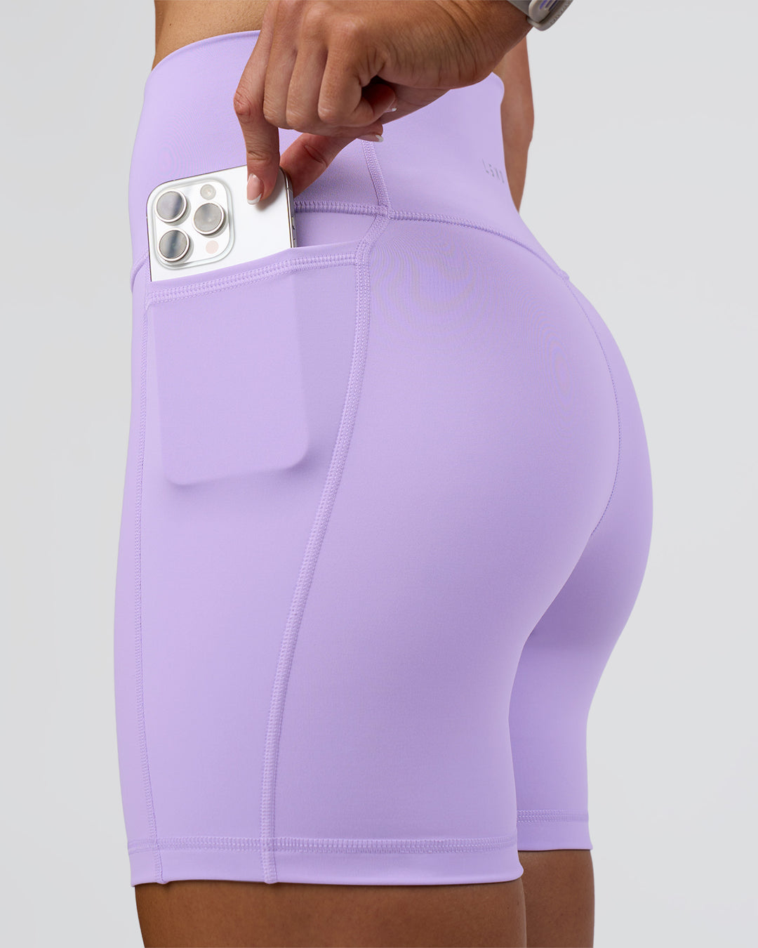 Woman wearing Fusion Ultra High-Rise 6" Short Pockets - Pale Lilac | Set:true | Angle:closeup | Model:Emelia | Size:S