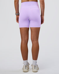 Woman wearing Fusion Ultra High-Rise 6" Short Pockets - Pale Lilac | Set:true | Angle:back | Model:Emelia | Size:S