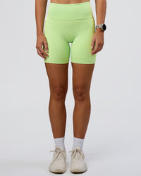 Woman wearing Fusion Ultra High-Rise 6" Short Pockets - Solar Lime | Set:true | Angle:front | Model:Emelia | Size:S
