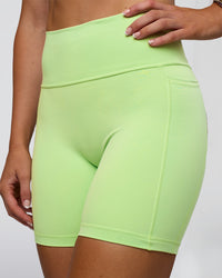 Woman wearing Fusion Ultra High-Rise 6" Short Pockets - Solar Lime | Model:Emelia | Size:S