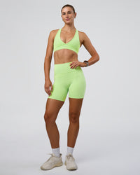 Woman wearing Fusion Ultra High-Rise 6" Short Pockets - Solar Lime | Model:Emelia | Size:S