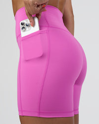 Woman wearing Fusion Ultra High-Rise 6" Short Pockets - Ultra Fuchsia | Set:true | Angle:closeup | Model:Abbey | Size:S