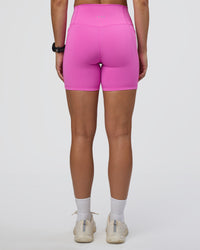 Woman wearing Fusion Ultra High-Rise 6" Short Pockets - Ultra Fuchsia | Set:true | Angle:back | Model:Abbey | Size:S
