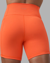 Woman wearing Fusion Ultra High-Rise 6" Short Pockets - Ultra Orange | Model:Katie | Size:S
