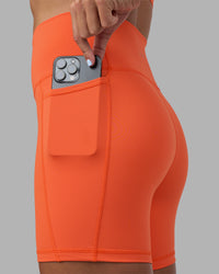 Woman wearing Fusion Ultra High-Rise 6" Short Pockets - Ultra Orange | Set:true | Angle:closeup | Model:Katie | Size:S