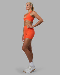 Woman wearing Fusion Ultra High-Rise 6" Short Pockets - Ultra Orange | Model:Katie | Size:S