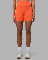 Woman wearing Fusion Ultra High-Rise 6" Short Pockets - Ultra Orange | Set:true | Angle:front | Model:Katie | Size:S