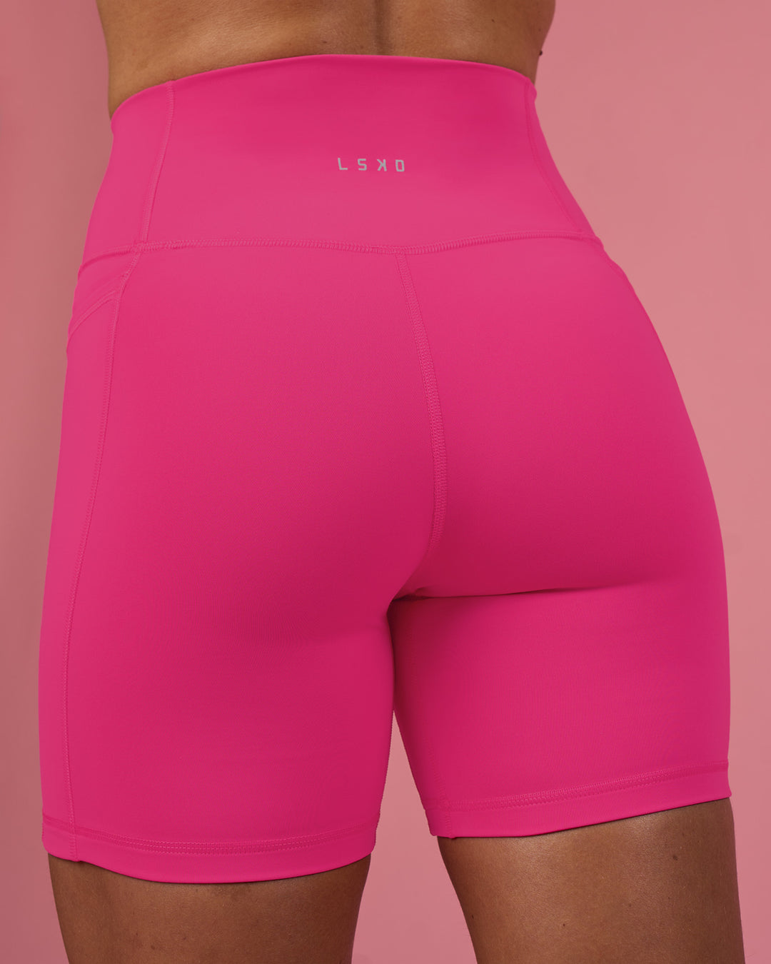 Woman wearing Fusion Ultra High-Rise 6&quot; Short Pockets - Ultra Pink | Model:Hannah | Size:S